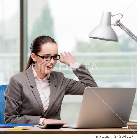 Businesswoman working at her desk 84594017