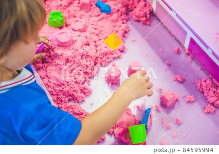 Boy playing with kinetic sand in preschool. The development of fine motor concept. Creativity Game concept Boy playing with kinetic sand in preschool. The development of fine motor concept. Creativity Game concept 84595994