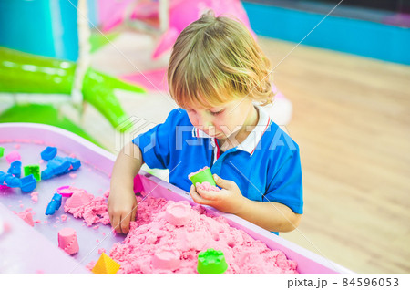 Boy playing with kinetic sand in preschool. The development of fine motor concept. Creativity Game concept 84596053