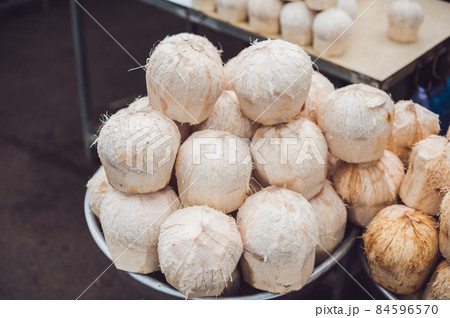 Coconuts in the Vietnamese market, typical street food business in Asia 84596570