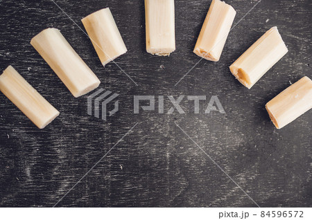Pieces of cane sugar on the old wooden background. Sugar concept 84596572