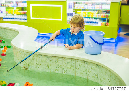 Cute boy in the playroom fishing. The development of fine motor concept. Creativity Game concept 84597767