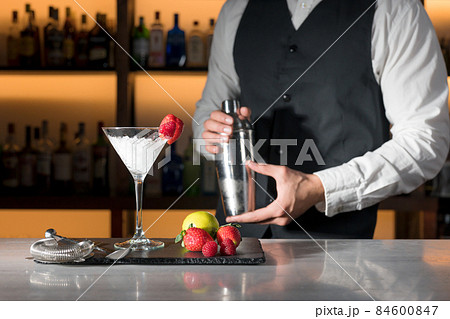 Expert barman is making cocktail at night club. 84600847
