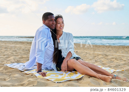 Outdoor portrait of happy young couple on sandy beach 84601329