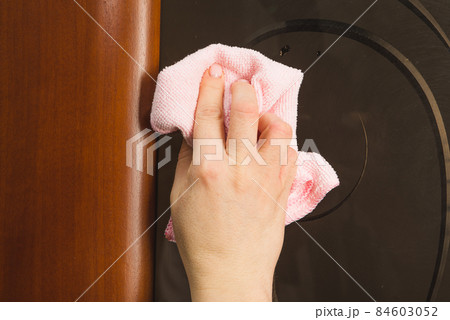 Hand with microfiber cloth cleaning car. 84603052