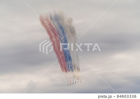 Russia. July 25, 2021. SU-25 combat aircraft during the Navy parade fly over Kronstadt and demonstrate the flag of the Russian Federation with smoke bombs. 84603336