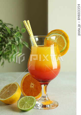 Tequila sunrise cocktail and ingredients on white textured table Tequila sunrise cocktail and ingredients on white textured table 84603354