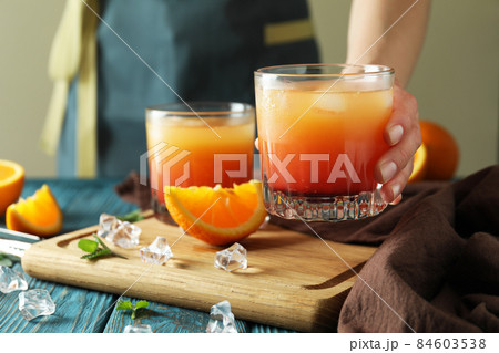 Concept of preparing Tequila sunrise cocktail on wooden table Concept of preparing Tequila sunrise cocktail on wooden table 84603538