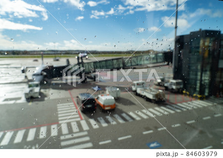 airplane waiting for departure in airport terminal, blurred horizontal background with rain drops. Transportation and logistics concept airplane waiting for departure in airport terminal, blurred horizontal background with rain drops. Transportation and logistics concept 84603979