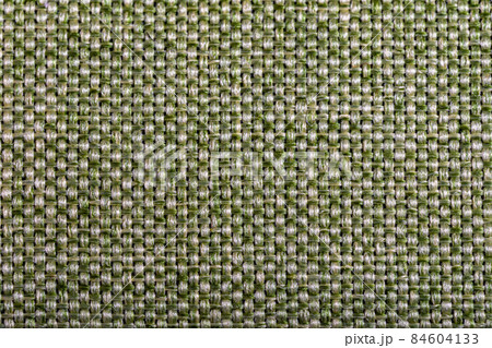 Green fabric texture. Furniture upholstery textiles. Embossed pattern. Woven fibers. The material is soft touch. Minimalism concept. High detail macro photography for backgrounds or wallpapers. 84604133