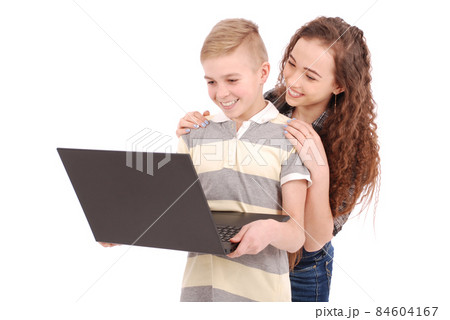 Boy and girl using a laptop isolated Boy and girl using a laptop isolated 84604167