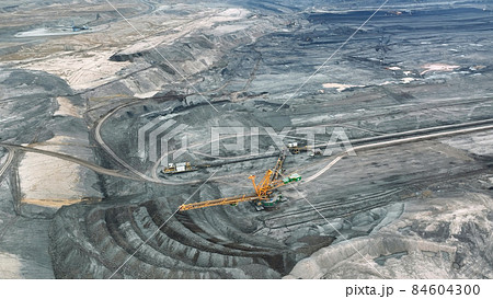 Brown coal opencast mine bucket wheel excavator giant Vrsany, aerial video shot view, open pit lignite heavy quarry, mining power plants burn energetics, dumpers quarrying extractive, extraction Czech Brown coal opencast mine bucket wheel excavator giant Vrsany, aerial video shot view, open pit lignite heavy quarry, mining power plants burn energetics, dumpers quarrying extractive, extraction Czech 84604300