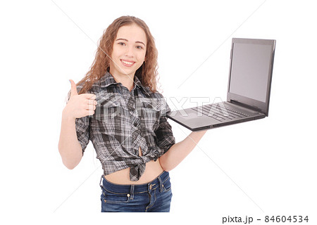 Young girl standing and using a laptop 84604534