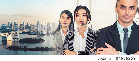Business people wearing headset working in office broaden view Business people wearing headset working in office broaden view 84606558