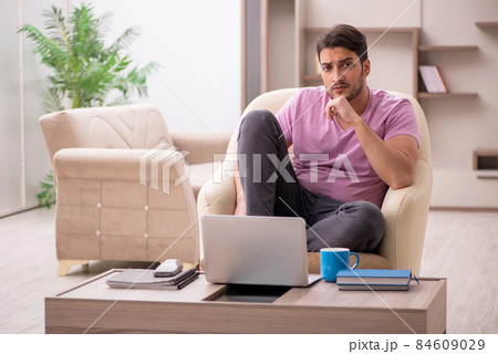 Young man working from home during pandemic 84609029