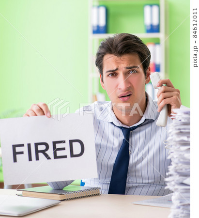Businessman having problems with paperwork and workload Businessman having problems with paperwork and workload 84612011