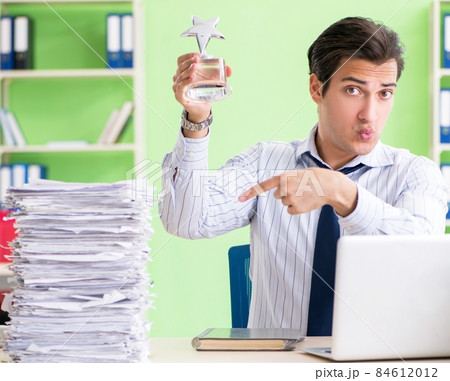Businessman having problems with paperwork and workload Businessman having problems with paperwork and workload 84612012