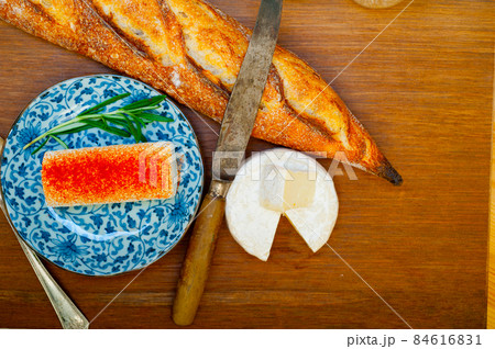 French cheese and fresh  baguette on a wood cutter 84616831