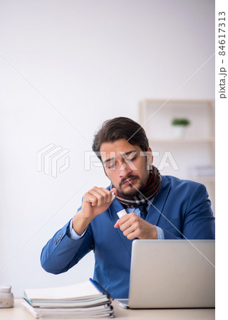 Young male employee suffering at workplace Young male employee suffering at workplace 84617313