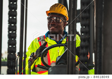 African american man driving forklift in shipyard African american man driving forklift in shipyard 84618049
