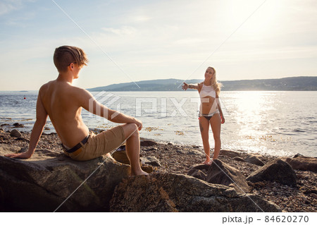 Young Real Couple Enjoying Sunset At Beach Young Real Couple Enjoying Sunset At Beach 84620270