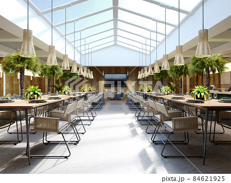 Luxurious restaurant with palm trees inside with a large glass atrium with wooden walls and fashionable furniture. 84621925