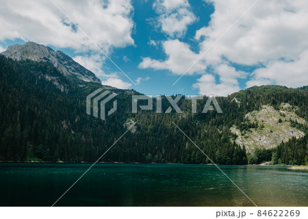Mountain lake in Durmitor National Park, Montenegro. BEAUTIFUL VIEW OF THE MOUNTAIN LANDSCAPE WITH CLEAR WATER AND BRIGHT BLUE SKY 84622269
