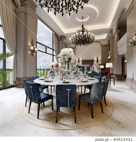 Large luxurious dining table in the large living room with high ceilings in a modern classic style with blue chairs and a white table. 84623431