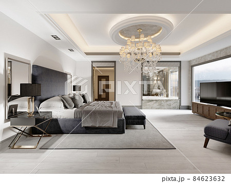 Luxurious bedroom with white walls and a gray fabric bed with black bedside tables and lamps and a large luminous crystal chandelier. 84623632