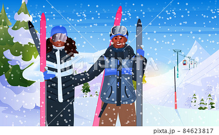 african american couple skiing tourists doing activities winter vacation concept snowfall landscape background african american couple skiing tourists doing activities winter vacation concept snowfall landscape background 84623817