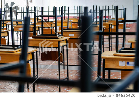 Desk and chairs in classroom 84625420