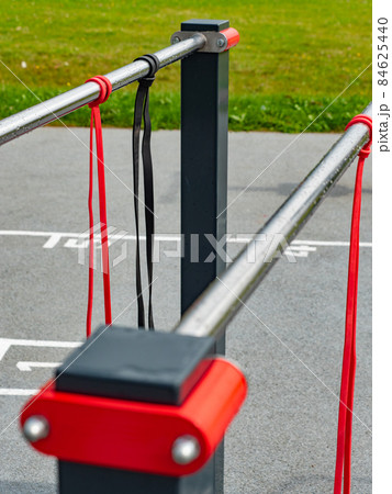 Exercise and stretching rubber elastic bands hanging on a workout rail. 84625440
