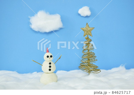 snowman near golden tree top star decoration in Christmas and new year festival with snow made by cotton diorama on sky background snowman near golden tree top star decoration in Christmas and new year festival with snow made by cotton diorama on sky background 84625717