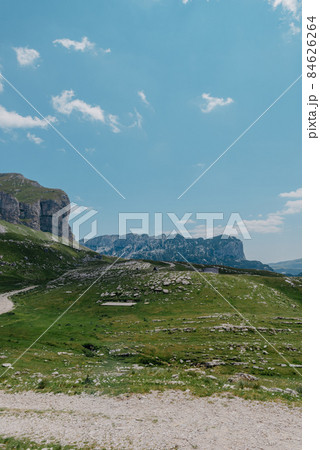 Amaizing view on Durmitor mountains, National Park, Mediterranean, Montenegro, Balkans, Europe. Bright summer view from Sedlo pass. The road near the house in the mountains. Amaizing view on Durmitor mountains, National Park, Mediterranean, Montenegro, Balkans, Europe. Bright summer view from Sedlo pass. The road near the house in the mountains. 84626264