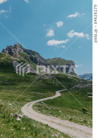 Amaizing view on Durmitor mountains, National Park, Mediterranean, Montenegro, Balkans, Europe. Bright summer view from Sedlo pass. The road near the house in the mountains. Amaizing view on Durmitor mountains, National Park, Mediterranean, Montenegro, Balkans, Europe. Bright summer view from Sedlo pass. The road near the house in the mountains. 84626279