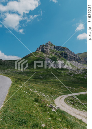 Amaizing view on Durmitor mountains, National Park, Mediterranean, Montenegro, Balkans, Europe. Bright summer view from Sedlo pass. The road near the house in the mountains. 84626282