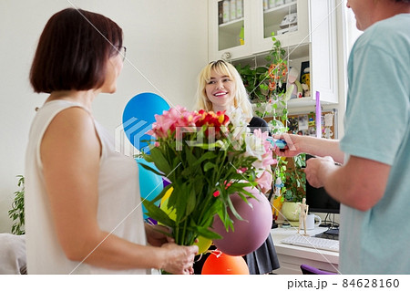 Parents congratulating teenage daughter with happy birthday 84628160