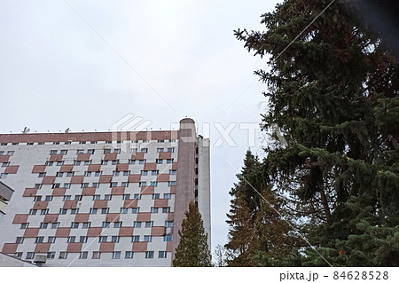 Tall building and treetops bottom view closeup Tall building and treetops bottom view closeup 84628528