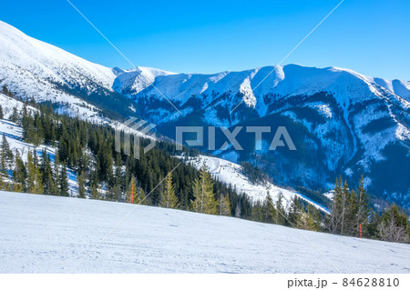 Sunny Weather Over Empty Ski Slope and Mountain Relief Sunny Weather Over Empty Ski Slope and Mountain Relief 84628810