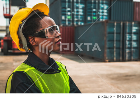 Young African American woman worker at overseas shipping container yard 84630309