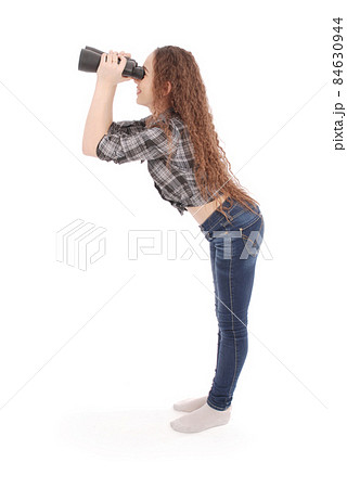 Attractive smiling young girl with binoculars 84630944