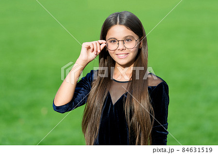 Happy small girl with long hair in fashion black dress Happy small girl with long hair in fashion black dress 84631519