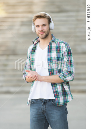 Modern man listening music wireless headphones, way to university concept Modern man listening music wireless headphones, way to university concept 84631910