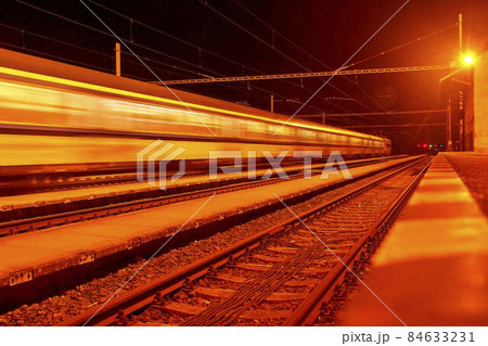 High speed passenger train on tracks with motion blur effect at night. Railway station in the Czech Republic 84633231