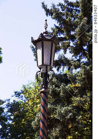 An old iron lantern. Garden electric lamp in the park An old iron lantern. Garden electric lamp in the park 84633407