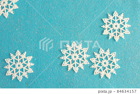 delicate christmas composition, snowflakes on blue felt background, copy space delicate christmas composition, snowflakes on blue felt background, copy space 84634157