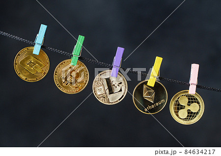Cryptocurrencies hanging on rope with clothes pins Cryptocurrencies hanging on rope with clothes pins 84634217