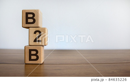 Concept word 'B2B' on cubes on a beautiful wooden table. White background. Business concept. Copy space. Concept word 'B2B' on cubes on a beautiful wooden table. White background. Business concept. Copy space. 84635226