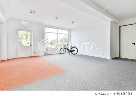 Huge bright room with large windows and a door to the outside Huge bright room with large windows and a door to the outside 84638452