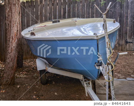 sailing dinghy on a trailer in backyard sailing dinghy on a trailer in backyard 84641643